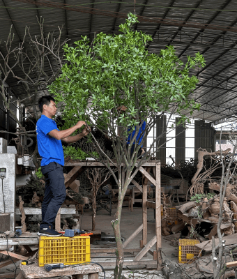 Worker crafting an artificial tree